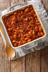 Delicious prebranac baked beans with onions close-up on a table. Vertical top view from above
