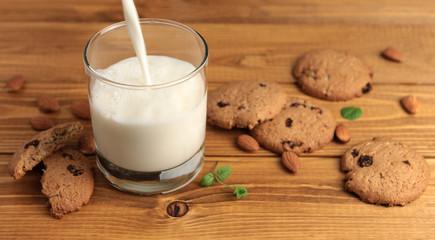 Glass of milk on a wooden background