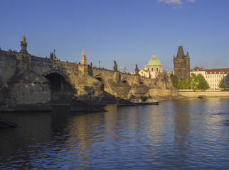 View of Charles Bridge in Prague, Czech Republic. Gothic Charles Bridge is one of the most visited sights in Prague. Architecture and landmark of Prague, golden light, sunny summer day