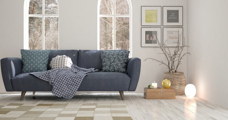 White room with sofa and winter landscape in window. Scandinavian interior design. 3D illustration