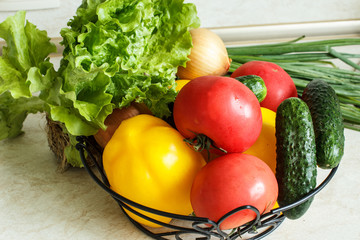 Fresh vegetables. Close-up. Cucumbers, tomatoes, peppers, duck and lettuce in a basket. Selective focus.
