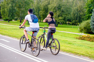 Fototapeta premium Cyclists ride on the bike path in the city Park 