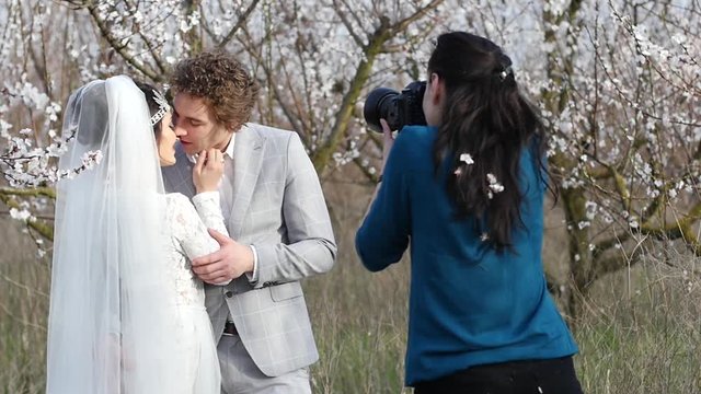 Beautiful couple newlyweds bride groom kissing hugging for photo shoot