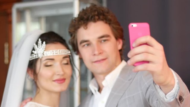 Young beautiful couple newlyweds taking selfie