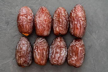 Fresh Medjool Dates in a bowl. Ramadan kareem. Black background. Top view. Copy space.