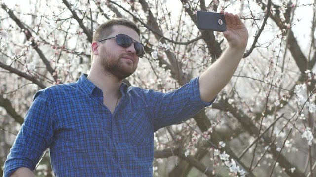 Man doing taking selfie photo picture via smart phone camera for social media