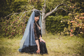 Gothic lady in a purple veil glamorous vintage look for Halloween. Beautiful citizen in vintage...