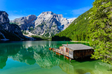 Lake Braies (also known as Pragser Wildsee or Lago di Braies) in Dolomites Mountains, Sudtirol, Italy. Romantic place with typical wooden boats on the alpine lake.  Hiking travel and adventure. 