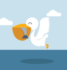 Pelican eating fish in sea