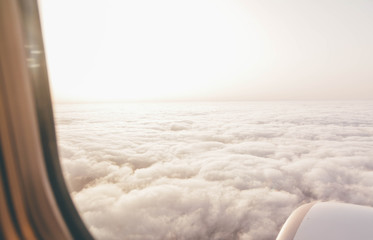 look trought plane window above clouds