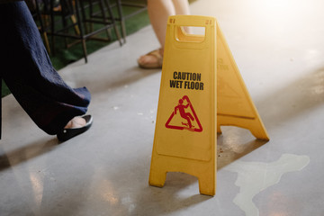Sign showing warning of caution wet floor whitin airport.