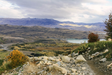 Beautiful, autumn rural landscape, with distant mountains, clouds and a small lake
