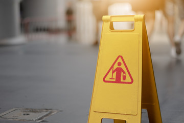 Sign showing warning of caution wet floor whitin airport.