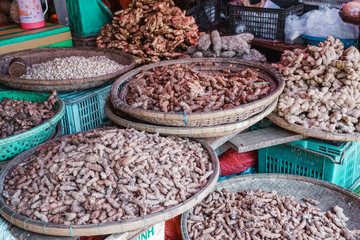 Various aromatic fresh, raw ingredients for sale at a market in Asia