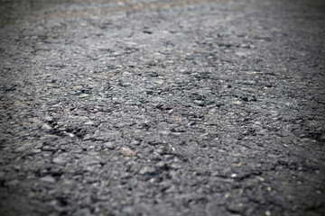 A dark grey asphalt pavement texture. Сlose-up of the repair of the road.