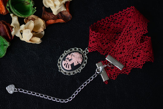 Halloween Necklace With Skeleton Cameo Pendant On A Dark Background Close Up