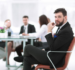 confident businessman on background of office.photo with copy space