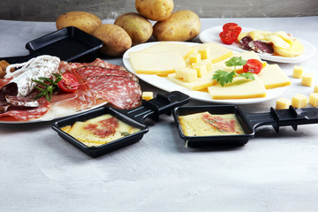Delicious traditional Swiss melted raclette cheese on diced boiled or baked potato.