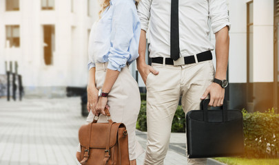 Fototapeta premium business guy and girl with briefcase in hands