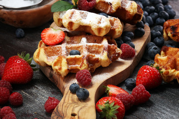 Traditional belgian waffles with fresh mint, sugar and raspberries.