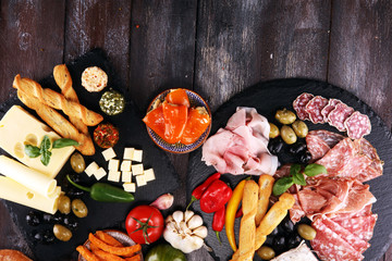Italian antipasti wine snacks set. Cheese variety, Mediterranean olives, pickles, Prosciutto di...