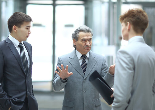 strict boss talking with an employee.photo on blurred office background