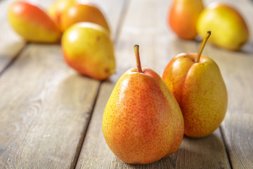 Ripe pears on rustic wooden table