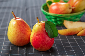 organic pears laying down on a lightly dotted kitchen cloth