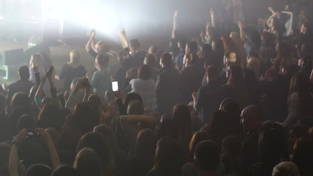 Crowd people fans enjoying a music concert stroboscope lumiere lights