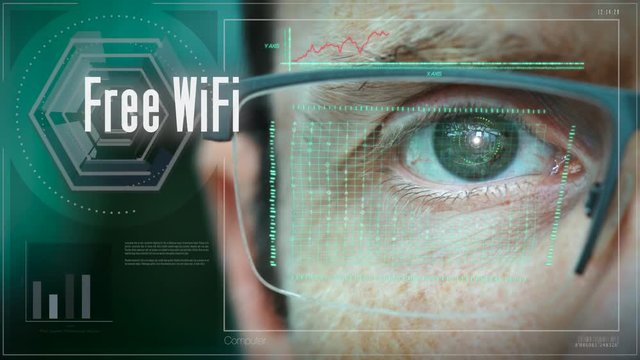 A close up of a businessman eye controlling a futuristic computer system with an Free Wifi concept.