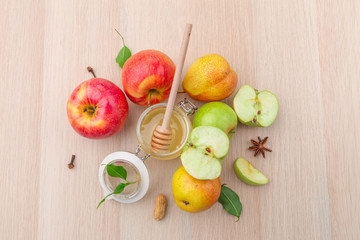 Naklejka na ściany i meble Jewish holiday Rosh Hashanah background with honey and apples on wooden table.