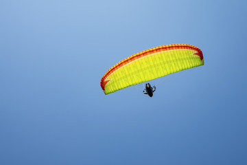 Parachutist on the background of blue sky.