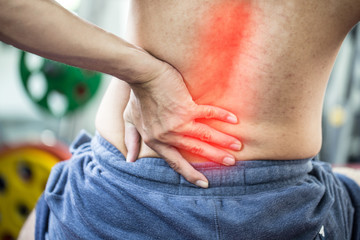 man have injury a back pain after workout in gym,Healthcare concept