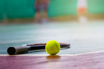 Tennis Ball and Racket on the Court