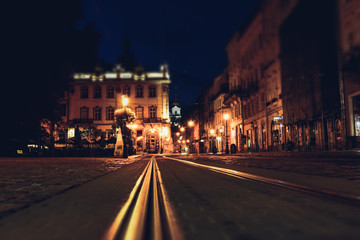 Old European city pedestrian street night city lights. Old architeccture illuminated street