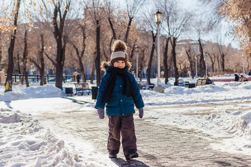 a little boy walks in Winter Park