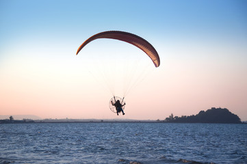 Traveler flying with para shoot on vacation time ,summer and holiday concept