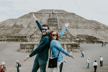 .Young carefree and lovely couple of tourist enjoying the pyramids of Teotihuacan in Mexico....