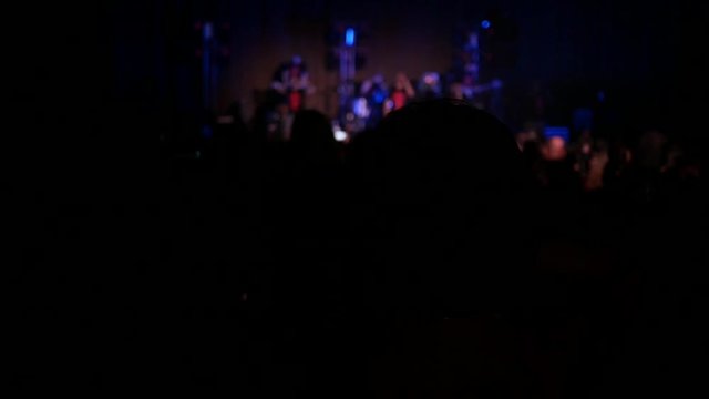 Fan girl spectator silhouette enjoying clapping hands in music concert
