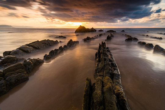 flysch rocks in barrika beach at the sunset