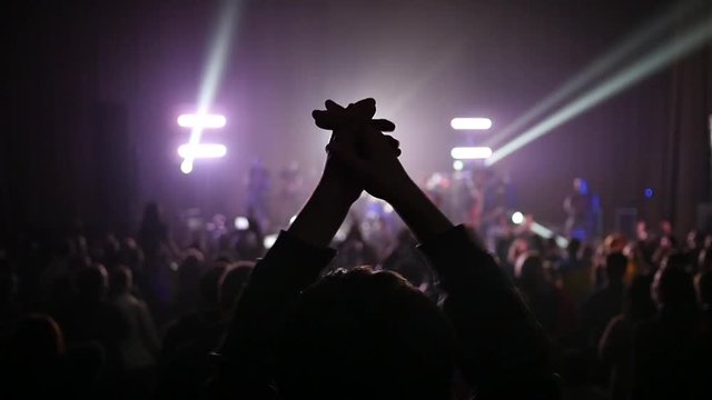  Fan spectator clapping hands up in air enjoying music concert light lumiere