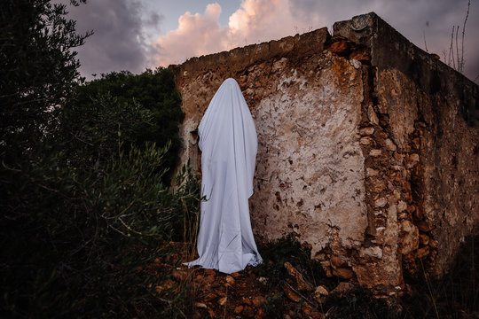 Ghost next to a ruined house