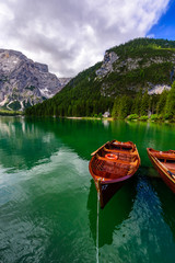 Lake Braies (also known as Pragser Wildsee or Lago di Braies) in Dolomites Mountains, Sudtirol, Italy. Romantic place with typical wooden boats on the alpine lake.  Hiking travel and adventure.