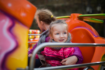 children on the carousel in autumn