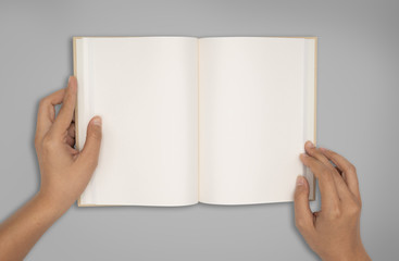 Top view- two hands hold a empty book spread
