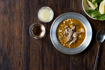 Turkish Soup Beyran with Lamb Meat, Rice, Chopped Garlic and Vinegar Sauce Served with Salad.