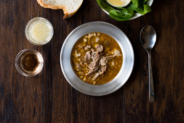 Turkish Soup Beyran with Lamb Meat, Rice, Chopped Garlic and Vinegar Sauce Served with Salad.