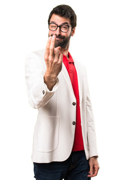 Brunette man with glasses doing coming gesture on white background