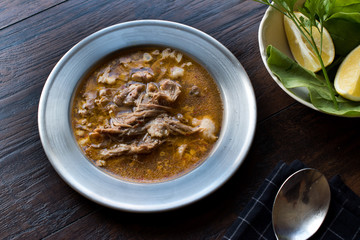 Turkish Soup Beyran with Lamb Meat, Rice, Chopped Garlic and Vinegar Sauce Served with Salad.