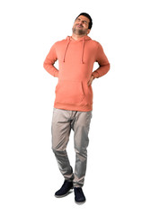 Full body of  Man in a pink sweatshirt with back pain on isolated white background